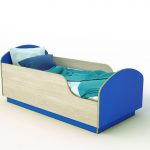 blue bed with a side for the boy