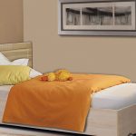 bed with an orange blanket