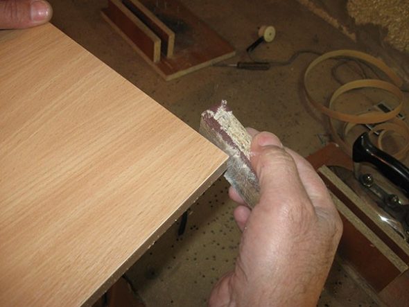 working the edge of the table sandpaper