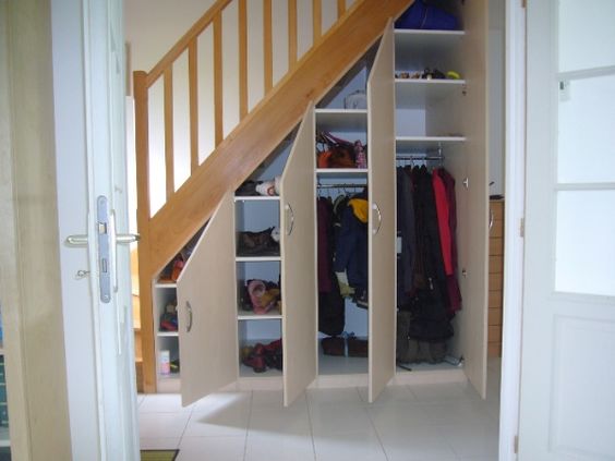 cupboard under the stairs with hinged doors