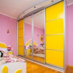 Sliding wardrobe to order in nursery of yellow color