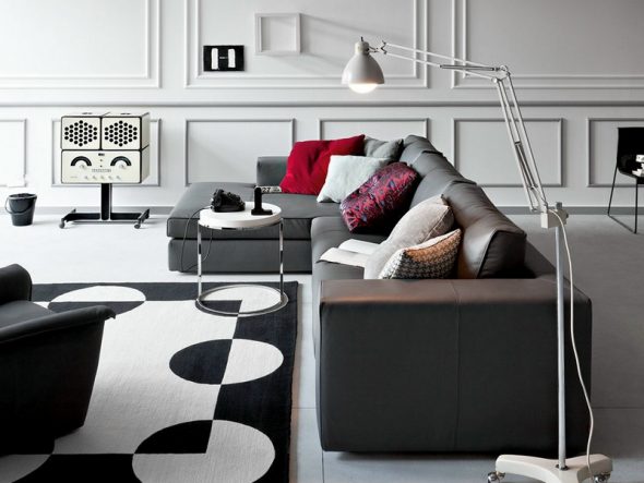 Dark gray corner sofa with red pillows
