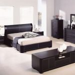 Black furniture and bright decoration of the walls and floor of the bedroom