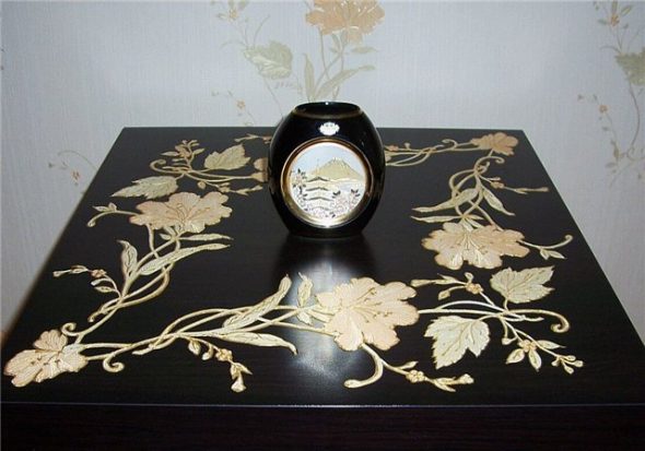 The table is decorated using decoupage technique with painted contours