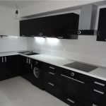 White table top and black sink in modern kitchen interior