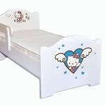 White baby bed with a side