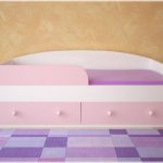 bed with a pink facade and side