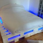 a bed of blue-lit pallets