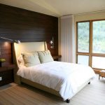 Wood paneling at the head of the bed in the bedroom