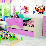 bright baby bed with a side