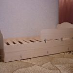 wooden bed with a side