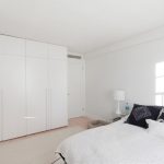 built-in na closet sa white bedroom