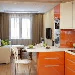 Orange color in the interior of the kitchen-living room