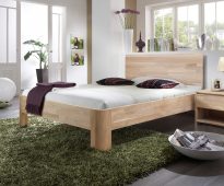 wooden bed in the bedroom