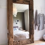 mirror in the bedroom in a wooden frame