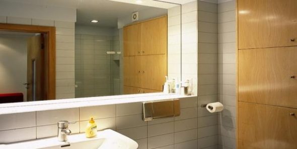 way to install a mirror in the bathroom is gluing in tiles