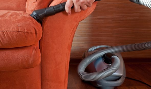 Cleaning upholstered furniture with a vacuum cleaner