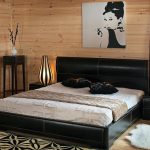 Double black bed with drawers in the photo