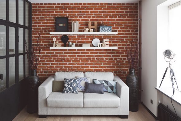 Shelves above the sofa in a small room