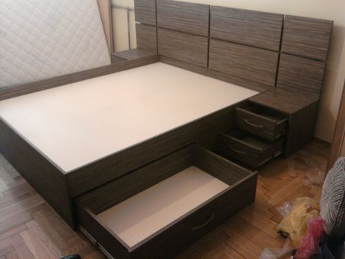 Bed with chipboard with storage boxes