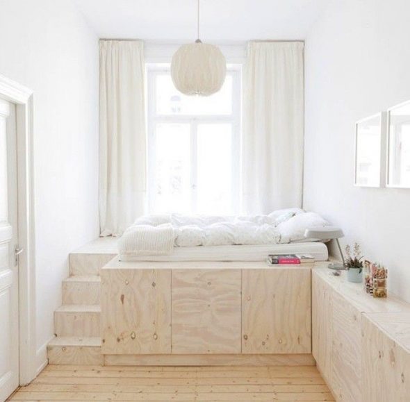 Wooden bed-podium in a small bedroom