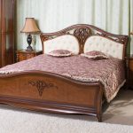Wooden bed with soft headboard