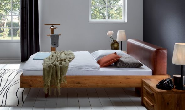 Wooden bed with soft headboard
