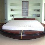 Unusual bedroom with a round bed with inserts for seating