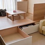 Podium for a bed with drawers and a folding table