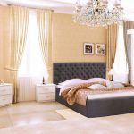 Elegant bedroom with a comfortable bed with a soft headboard