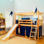 Children's loft bed in the form of a fortress with a play area at the bottom and a slide