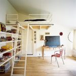 Bed with sloping stairs and bookshelves