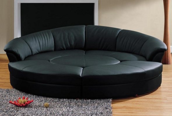 The round sofa bed is transformed into separate seats and a table