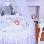 Newborn baby in a round crib