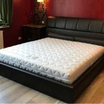 Black leather bed with a soft back