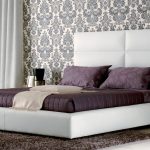 White double bed with a big soft headboard