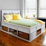 Wooden bed with open shelves at the bottom