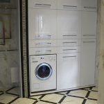 Huge cupboard in the niche with a washing machine