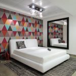 Modern bedroom with a bright accent on the wall at the head of the bed