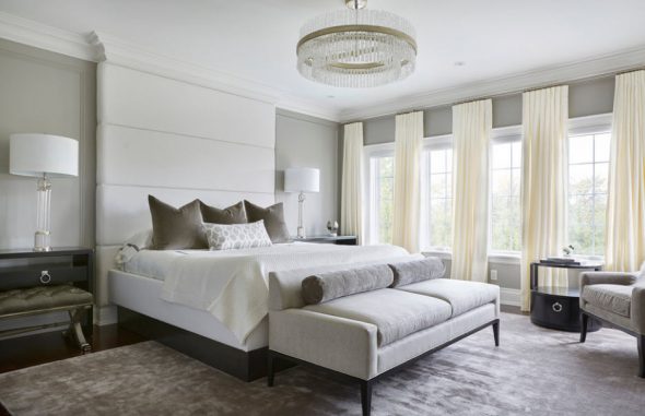 Stylish bedroom with soft headboard to the ceiling.