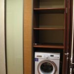 Built-in closet in the hallway with a washing machine