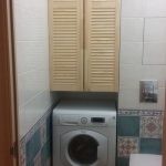 Built-in wardrobe above the washing machine with drawers