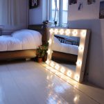 Mirror with light near the bed