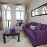Purple sofa and striped chair