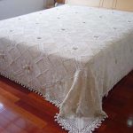 Openwork white blanket on the bed