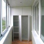 Two-piece built-in wardrobe of chipboard is equipped with spacious sections