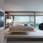A bed with the effect of soaring in the center of the spacious bedroom