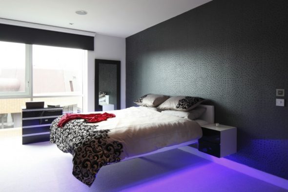 Dark wallpaper and soaring bed