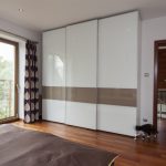 Tall white wardrobe in the bedroom