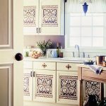 White cabinets with original drawings on the doors